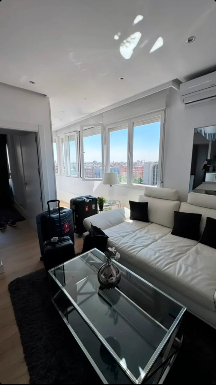 Bright living room with suitcases after arriving in Madrid